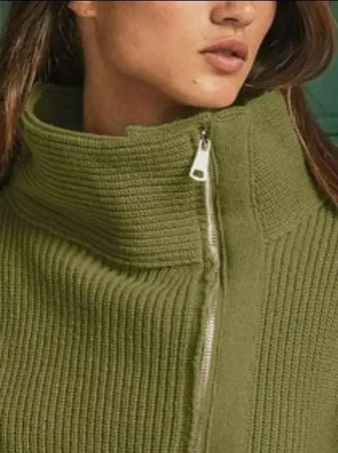 Close-up of olive ribbed knit sweater with silver zipper and cozy texture — elevated women’s knitwear from Atlas by J&D.