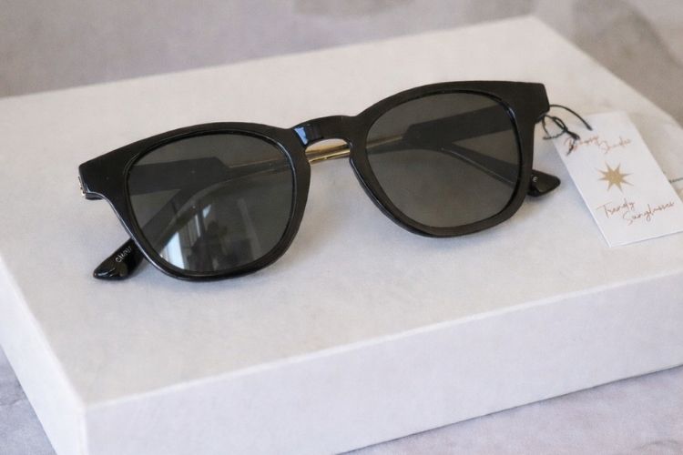 Black Sunglasses on White Display with Neutral Background