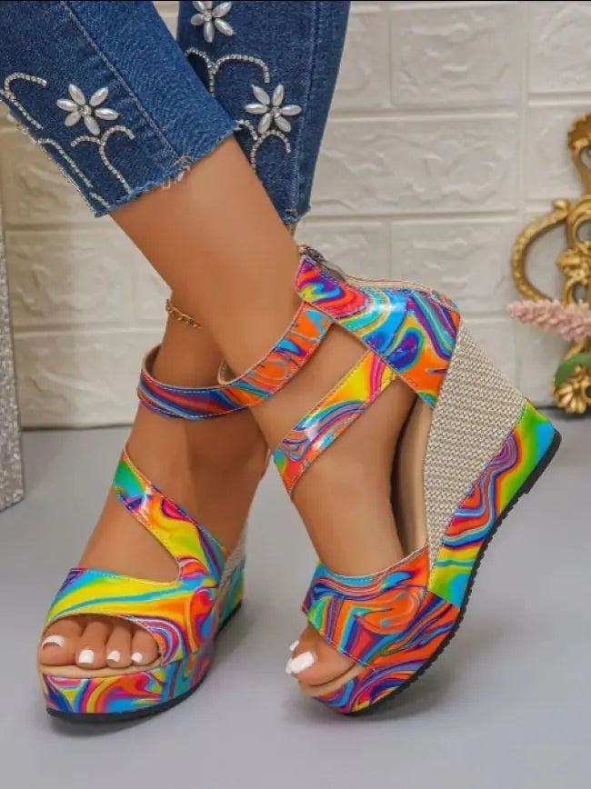 Colorful platform sandals worn with a denim outfit on a light background.