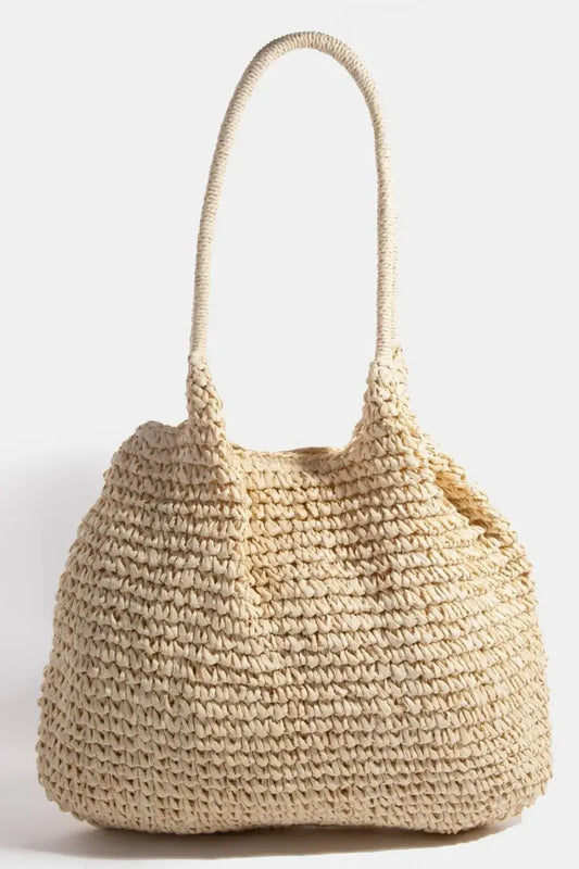 Woven straw handbag on a white background