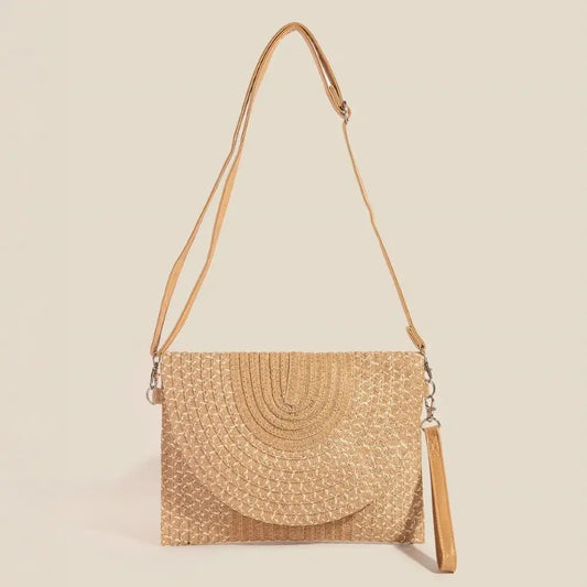 Woven envelope-style handbag with a strap on a beige background.