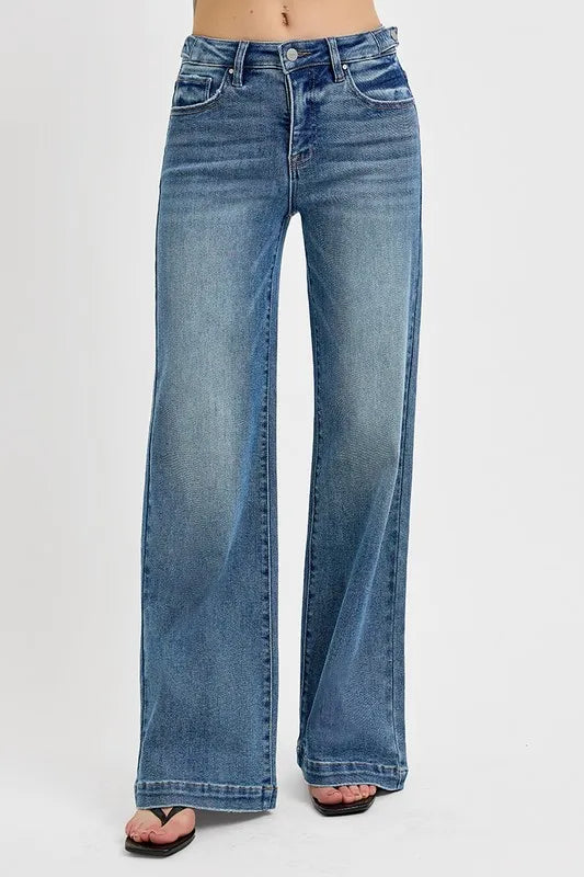 Wide leg adjustable blue jeans on a white background