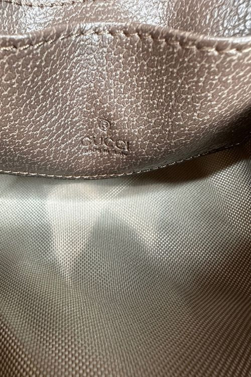 Close-up of a textured surface with a brand logo, possibly Gucci.