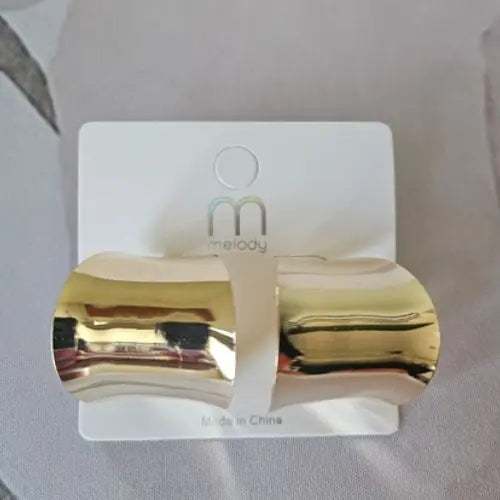 Polished gold cuff earrings with sculptural curved shape — Atlas by J&D women’s boutique jewelry.