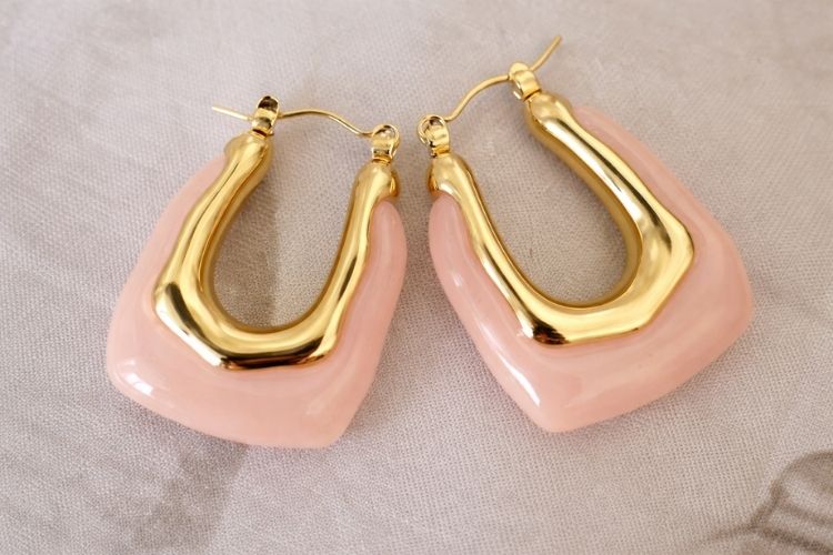 Pair of Pink Stone Earrings with Clasp closure on neutral background