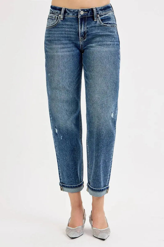 Cropped blue jeans with a slight fade on a white background