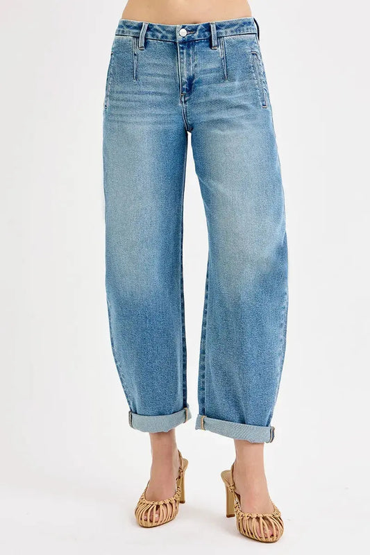 Light blue jeans with rolled-up cuffs on a white background
