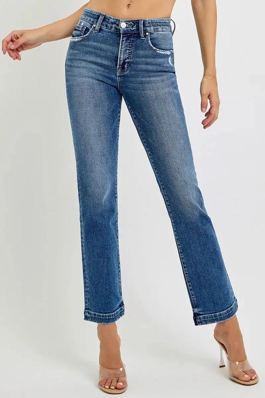 Cropped blue jeans with an elastic waist band worn by a person on a white background