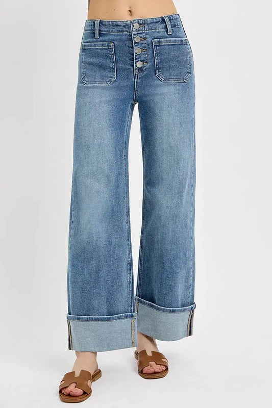 Cuffed wide-leg jeans with a button fly on a white background