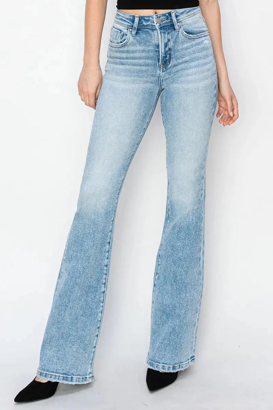 Light blue bootcut jeans worn by a person on a white background