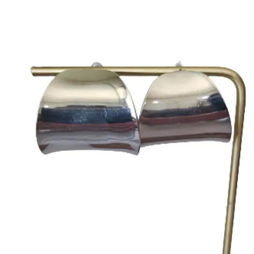 Silver cuff-style earrings displayed on jewelry stand — elevated women’s accessories from Atlas by J&D.