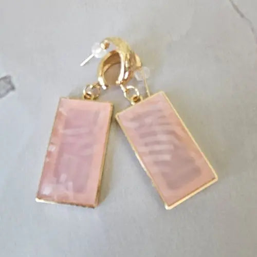 Gold hoop earrings featuring glossy blush pink resin pendants with soft shimmer — women’s boutique jewelry by Atlas by J&D.
