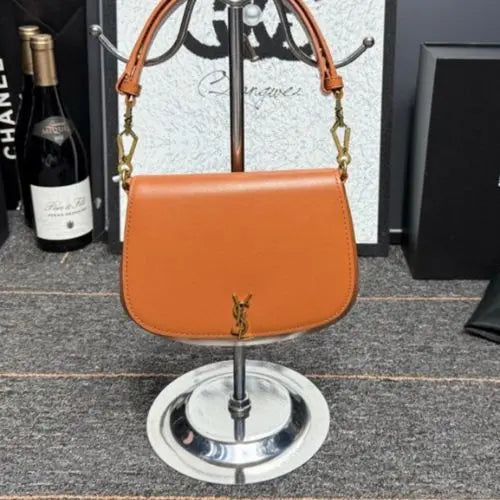 Crafted from premium materials, it offers a spacious interior, a secure magnetic closure, and an adjustable top handle, allowing for versatile carrying options—whether as a handbag or shoulder bag. Perfect for both day and evening wear, this piece blends Parisian-inspired elegance with modern functionality, making it a must-have accessory for any wardrobe.