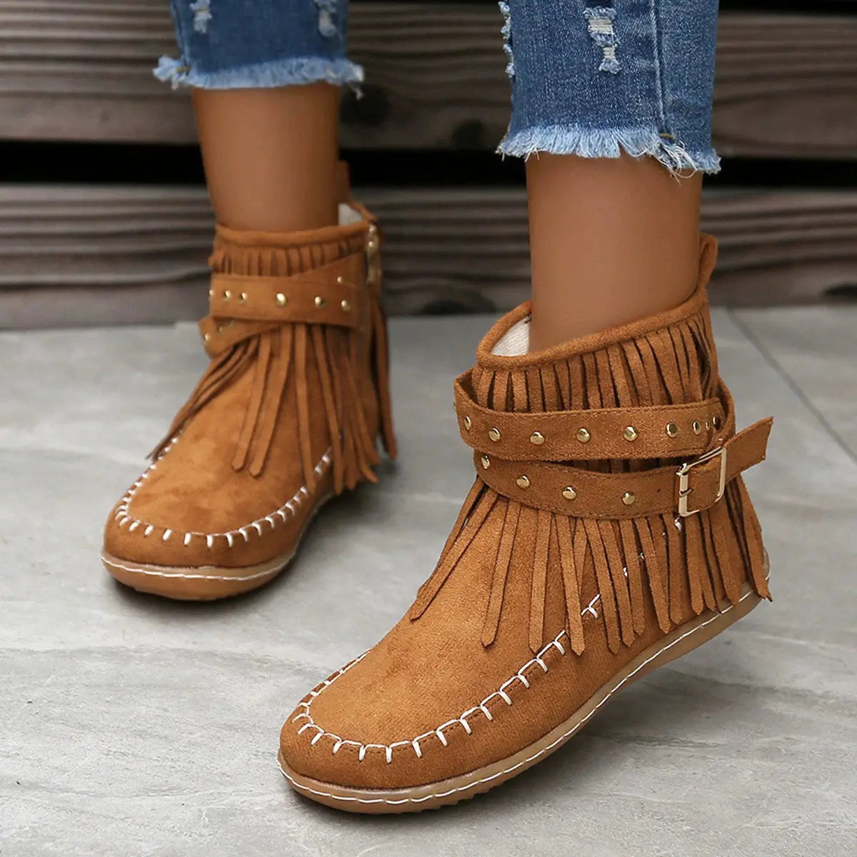 Earthy Tones set the tone for effortless style in these studded fringe suede flat boots by Grace Step. Designed to feel like a second skin, the vegan suede contours gently to your foot, creating a balanced mix of grounded elegance and playful charm. Whether dressing up denim or offsetting a neutral maxi dress, this boot adds instant personality to any look.