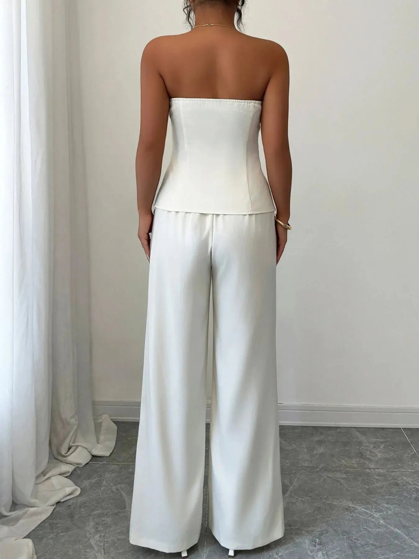 Crafted from a luxe, breathable fabric with a subtle sheen, this set balances comfort and sophistication. The wide-leg cut elongates the frame, making it ideal for heels or sleek flats. Whether you're presenting in the boardroom or sipping cocktails at a rooftop lounge, this ensemble adapts to your agenda with style.
