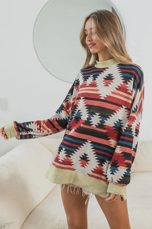 This stylish oversized long sleeve t-shirt features a vibrant Aztec geometric print in rich earth tones including coral, navy, and cream. Made from soft cotton blend fabric for ultimate comfort and breathability. The relaxed fit design offers a flattering silhouette while providing freedom of movement. Perfect for casual wear, weekend outings, or layering. The tribal-inspired pattern adds a bohemian touch to any wardrobe. Machine washable for easy care. Ideal for spring and fall seasons.
