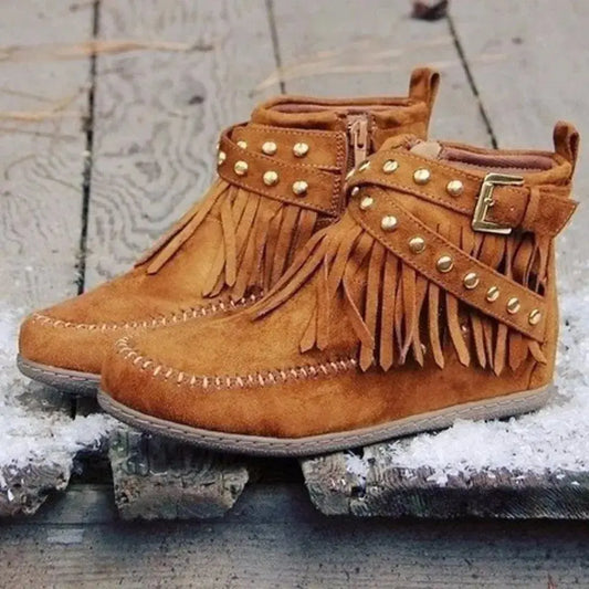 Earthy Tones set the tone for effortless style in these studded fringe suede flat boots by Grace Step. Designed to feel like a second skin, the vegan suede contours gently to your foot, creating a balanced mix of grounded elegance and playful charm. Whether dressing up denim or offsetting a neutral maxi dress, this boot adds instant personality to any look.