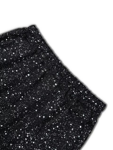 Close up detail of black jogger pants featuring allover glitter speckle for a stylish sparkle finish.