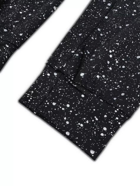 Detail view of glitter on the black fabric showing shimmer texture near the hem.