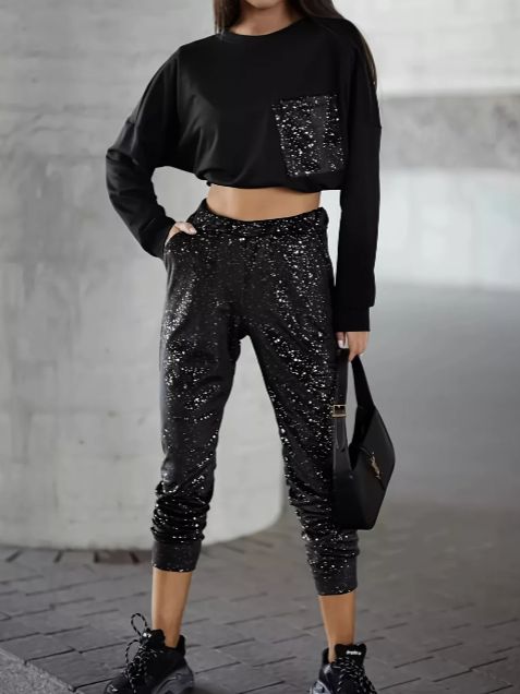 Black glitter pocket long sleeve top paired with glitter jogger pants creating a coordinated loungewear outfit.