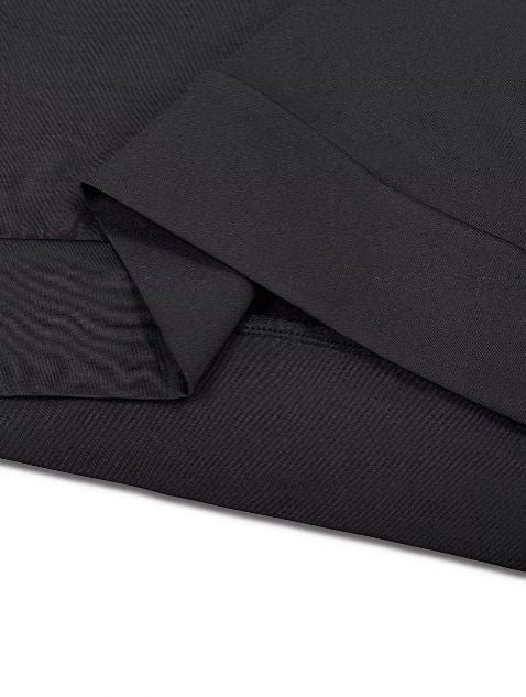 Close up of soft black knit fabric showing smooth stretch texture for comfortable wear.