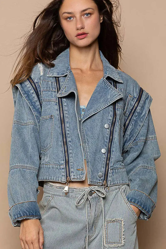 This fashion oversized cropped denim jacket features a vintage-inspired design with premium cotton denim construction. The jacket showcases a relaxed fit with dropped shoulders and a cropped hemline that pairs perfectly with high-waisted bottoms. Multiple zipper accents add edgy detail while the classic blue wash provides versatile styling options. The structured collar and lapels create a sophisticated silhouette, making it ideal for layering over casual outfits or dressing up everyday looks.