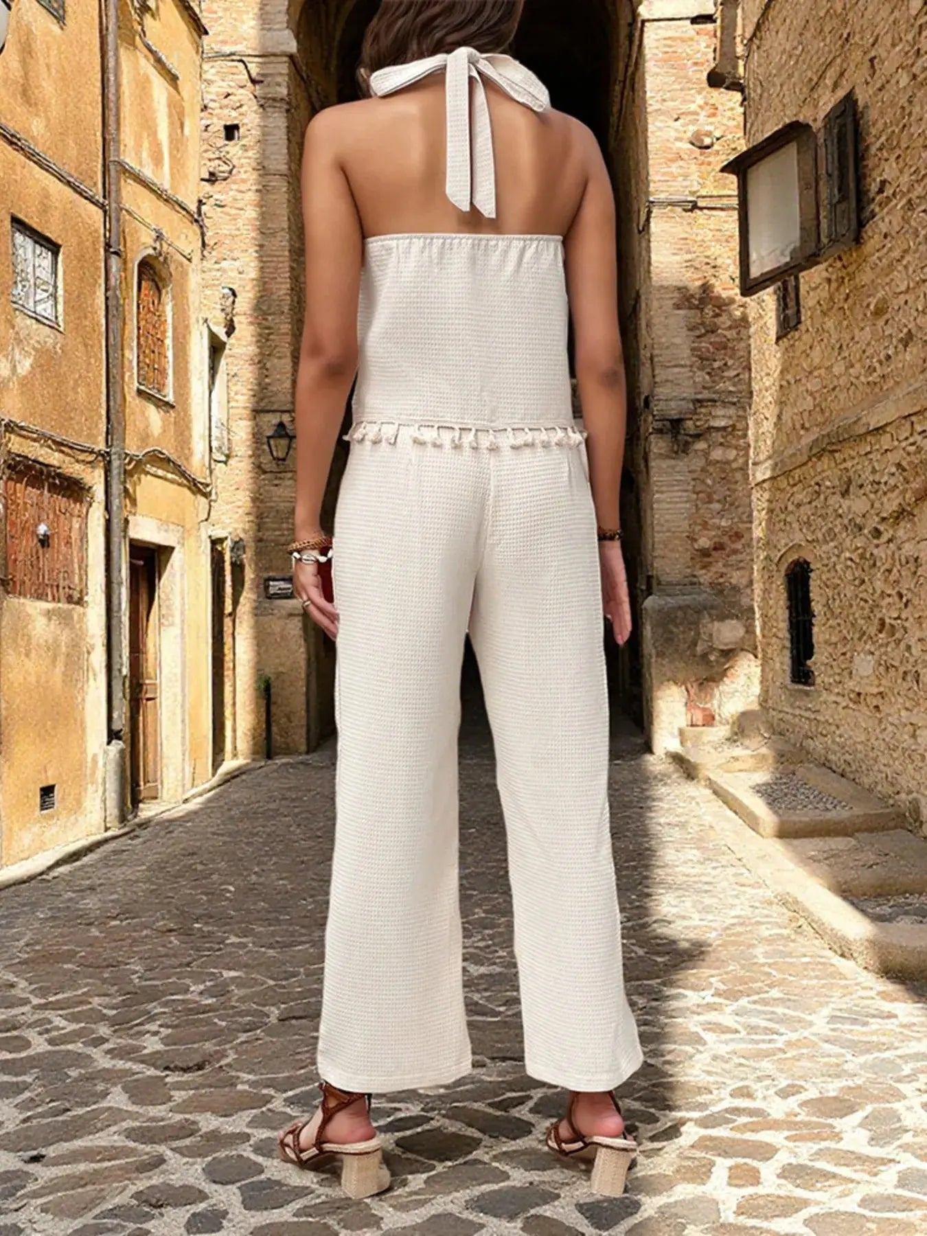 Step into effortless elegance with this halter neck cami and pants set, designed for sun-drenched days and breezy escapes. The cami features a flattering halter neckline that highlights the shoulders and collarbone, while the open back adds a touch of allure. Its lightweight, breathable fabric keeps you cool and comfortable, making it ideal for warm-weather adventures or leisurely afternoons.