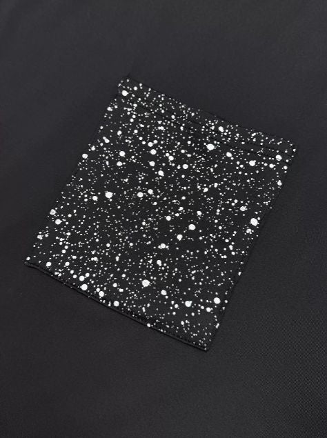 Sparkling glitter pocket on black fabric adding a glam touch to a casual long sleeve top.