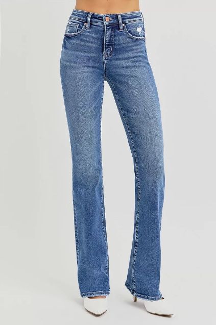 Medium wash high rise flare jeans with a clean front and subtle fading, shown on model from the front to highlight the long flared leg.