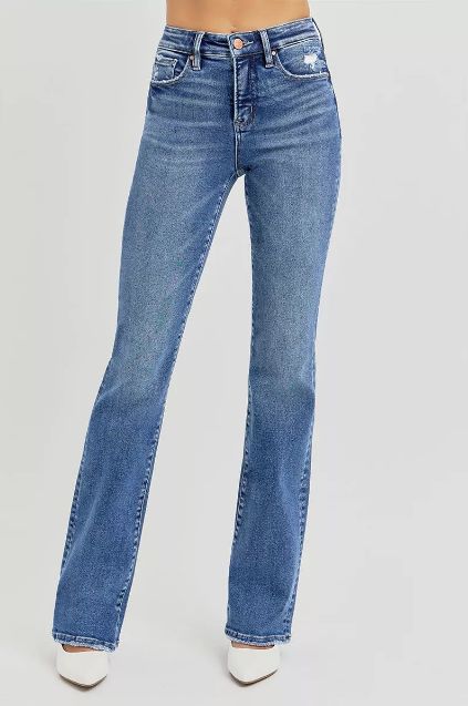 Full body front view of medium wash high rise flare jeans with a long flared hem and easy everyday fit. The model stands straight to show the full silhouette.