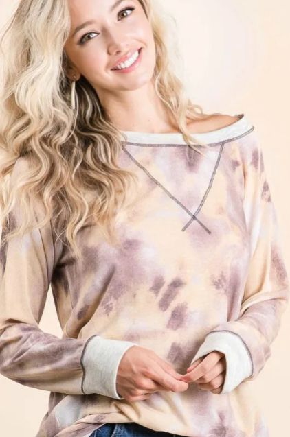 Neutral tie dye long sleeve top styled with denim shorts, showing the relaxed neckline and comfortable drape.