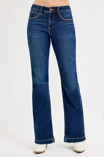 High rise Risen flare jeans in a classic medium wash with a long, full-length flare silhouette.