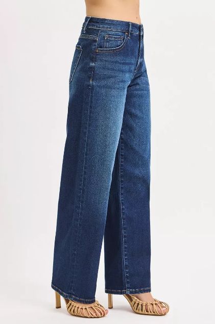 Side view of Risen high rise wide leg jeans featuring a straight drape and soft fading.